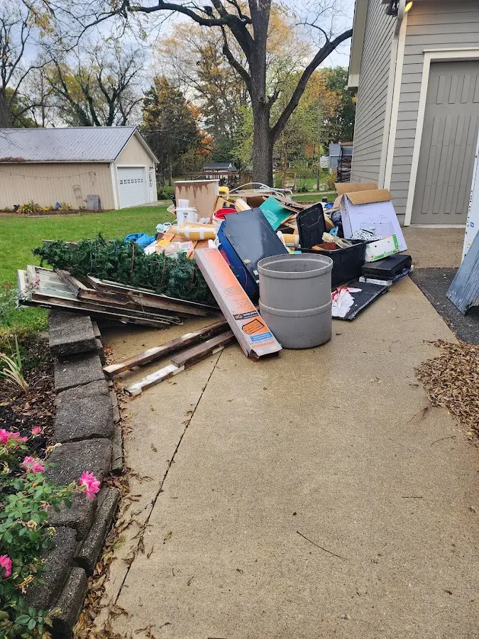 Dumpster being loaded with debris for 10 Yard Dumpster Rental in Apollo Beach